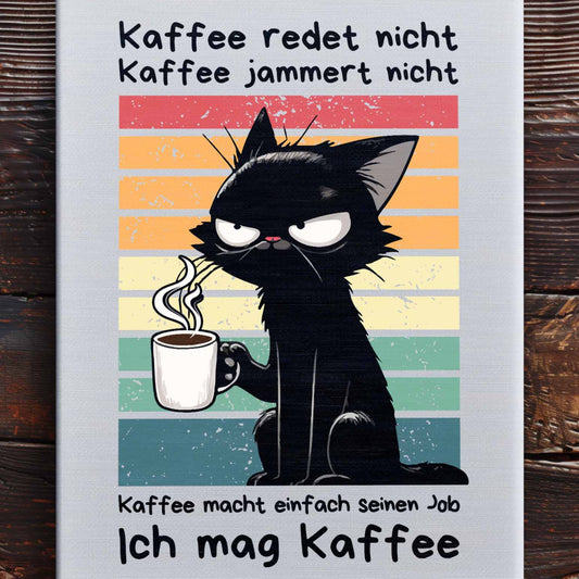 Nahaufnahme 90x120 cm große Leinwand auf Holzboden mit Design einer Katze mit Kaffeetasse und dem lustigen Spruch 'Ich mag Kaffee'