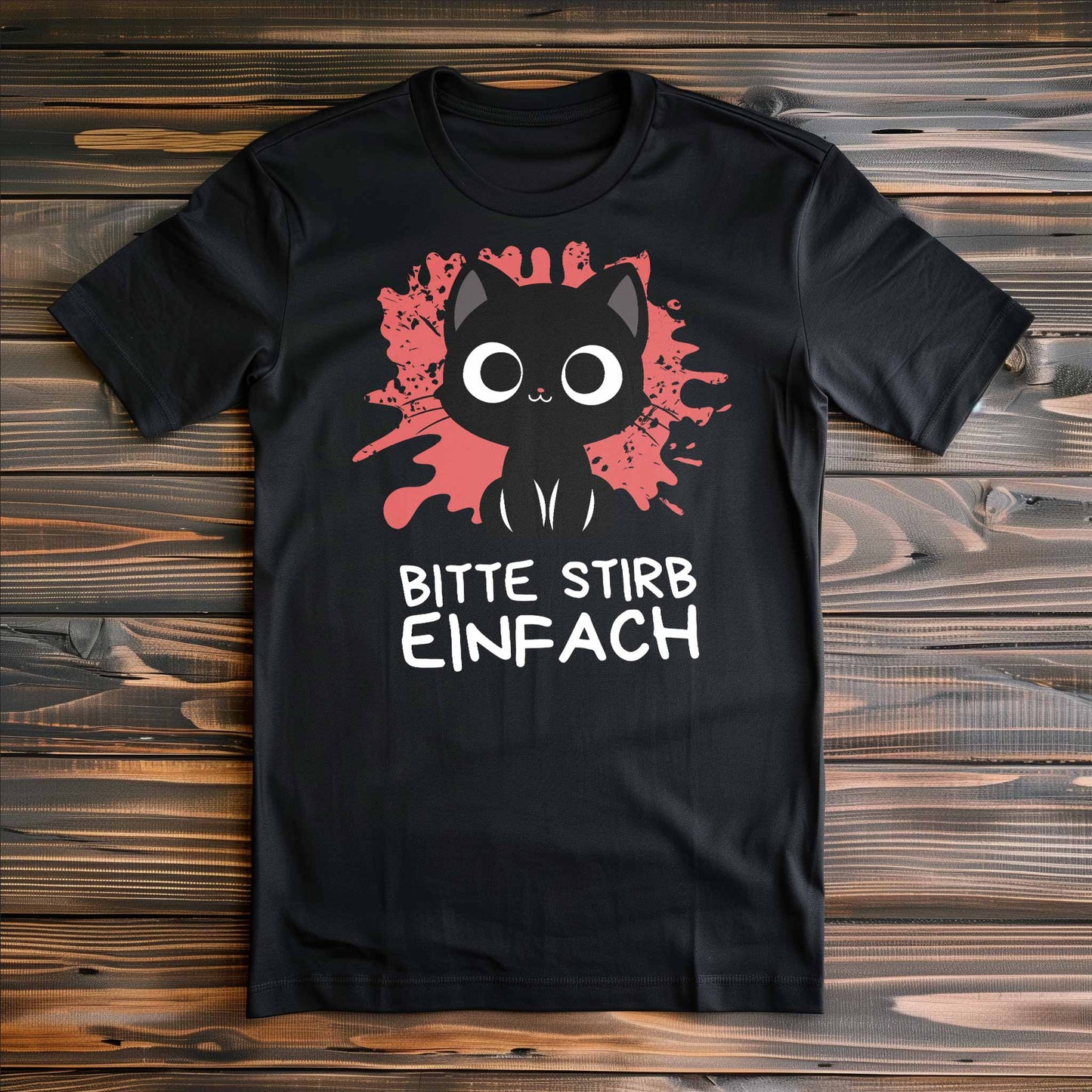 Schwarzes T-Shirt auf Holzboden mit Design einer süßen schwarzen Katze und dem lustigen Spruch 'Bitte stirb einfach'